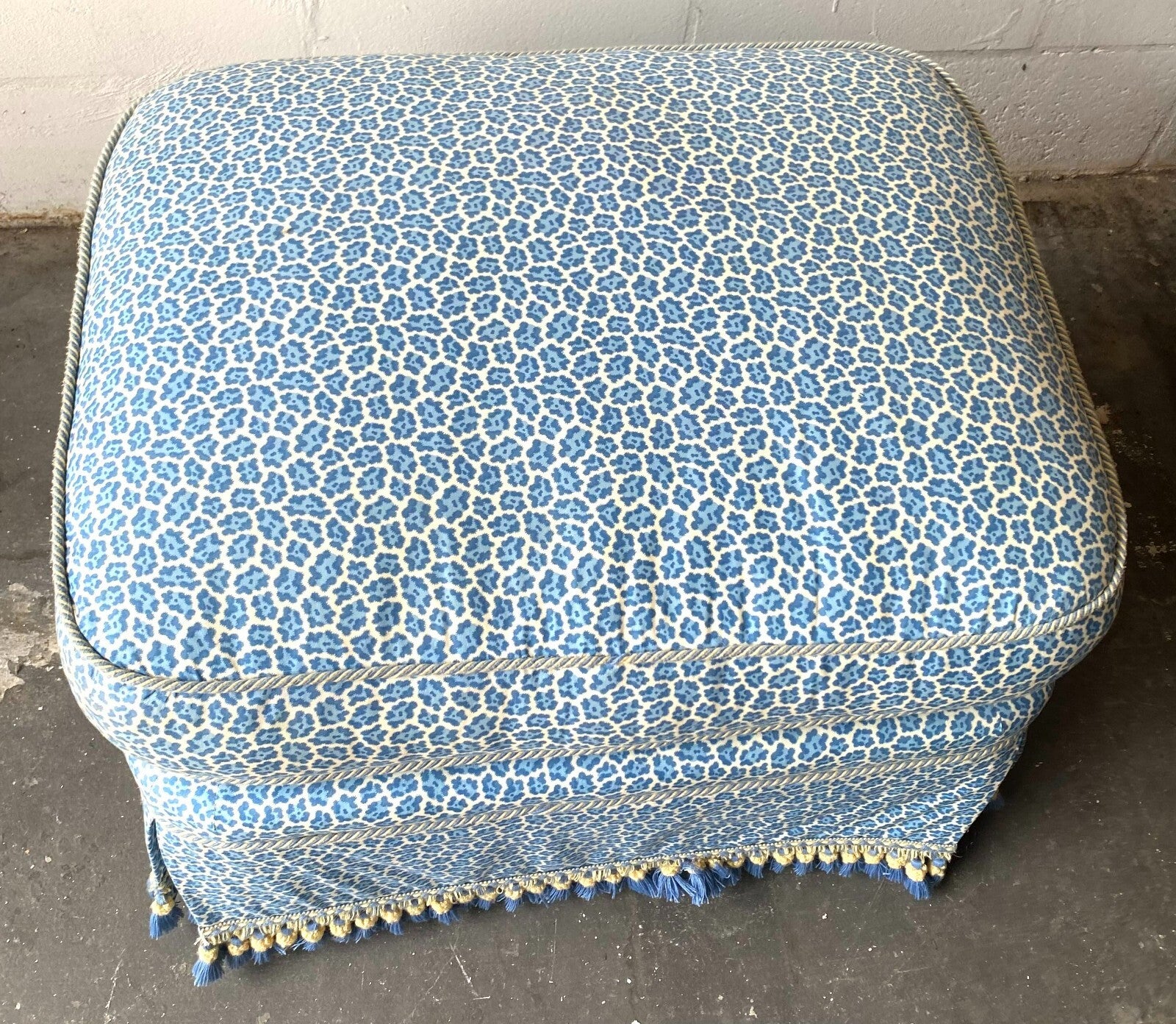 Beige Wicker Chair With Arm Rest Blue Cushion And Square Matching Ottoman