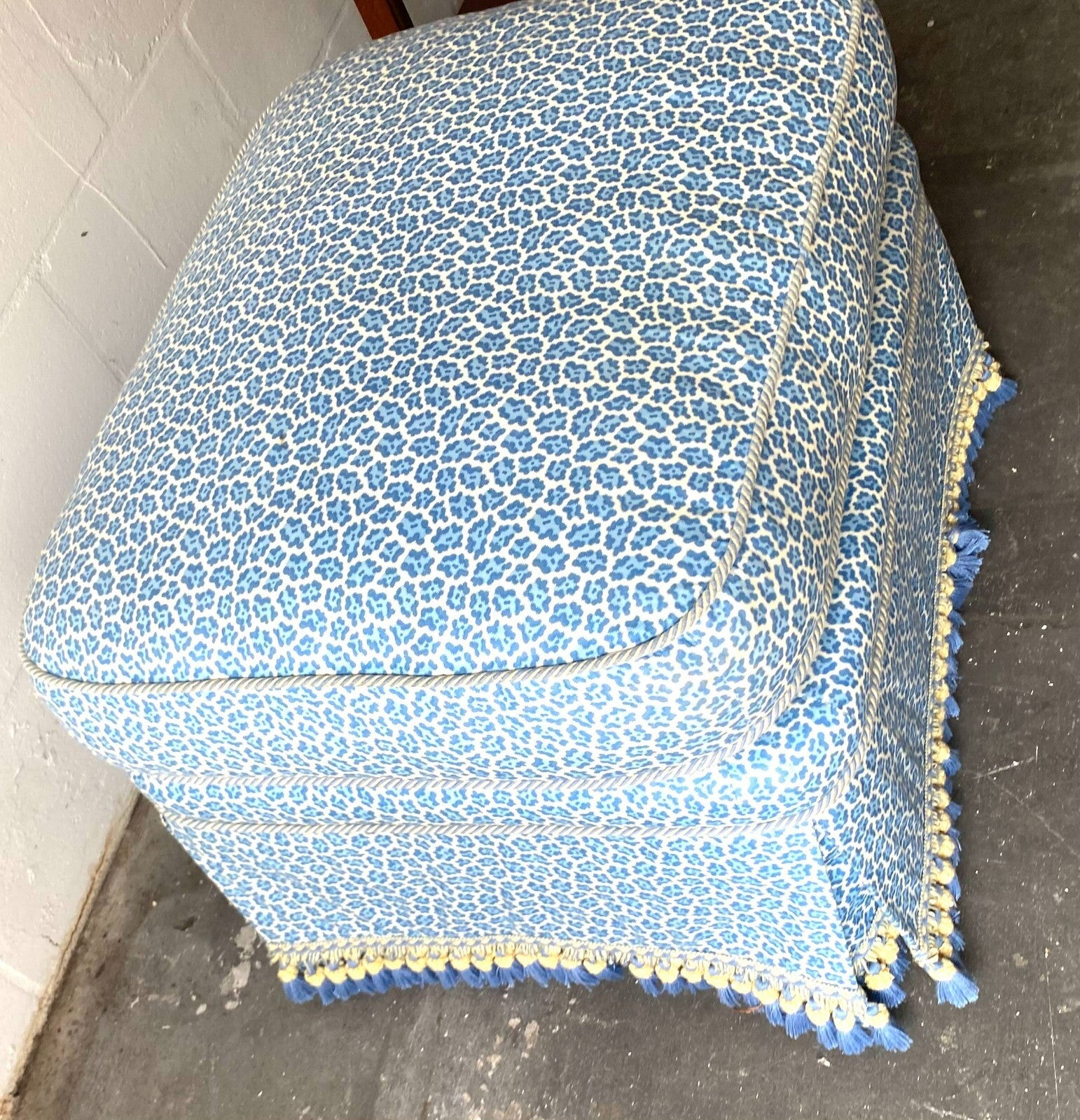 Beige Wicker Chair With Arm Rest Blue Cushion And Square Matching Ottoman