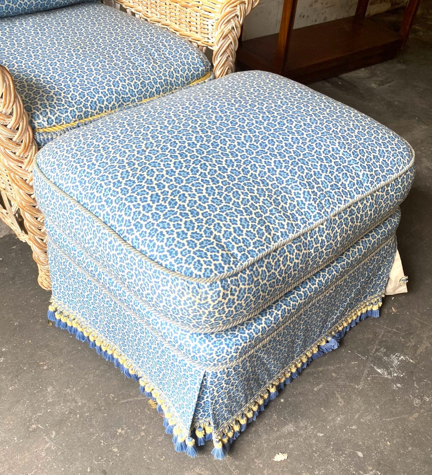 Beige Wicker Chair With Arm Rest Blue Cushion And Square Matching Ottoman