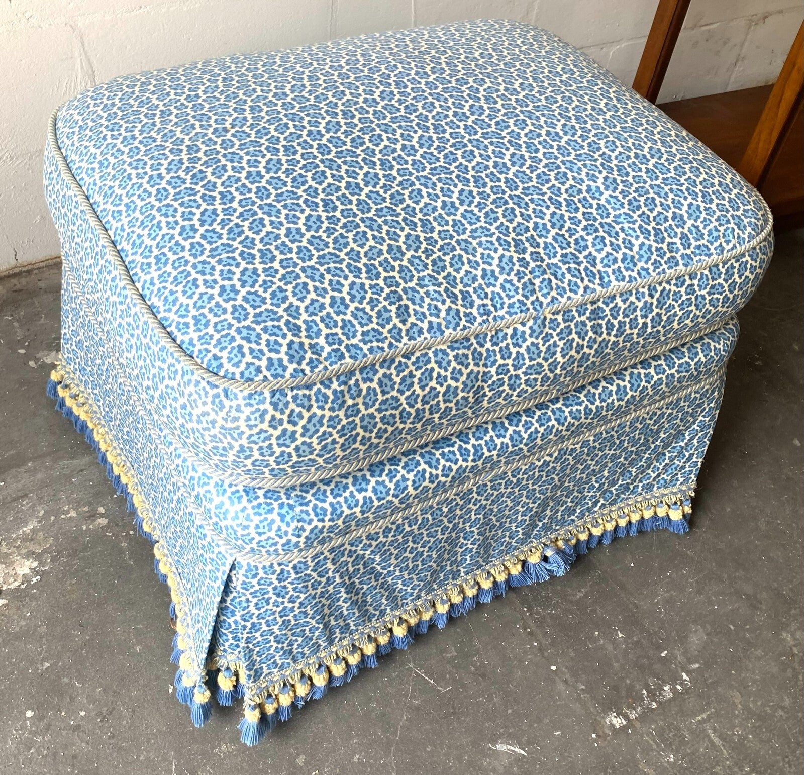 Beige Wicker Chair With Arm Rest Blue Cushion And Square Matching Ottoman