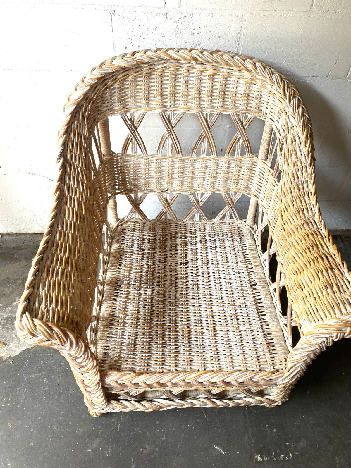 Beige Wicker Chair With Arm Rest Blue Cushion And Square Matching Ottoman