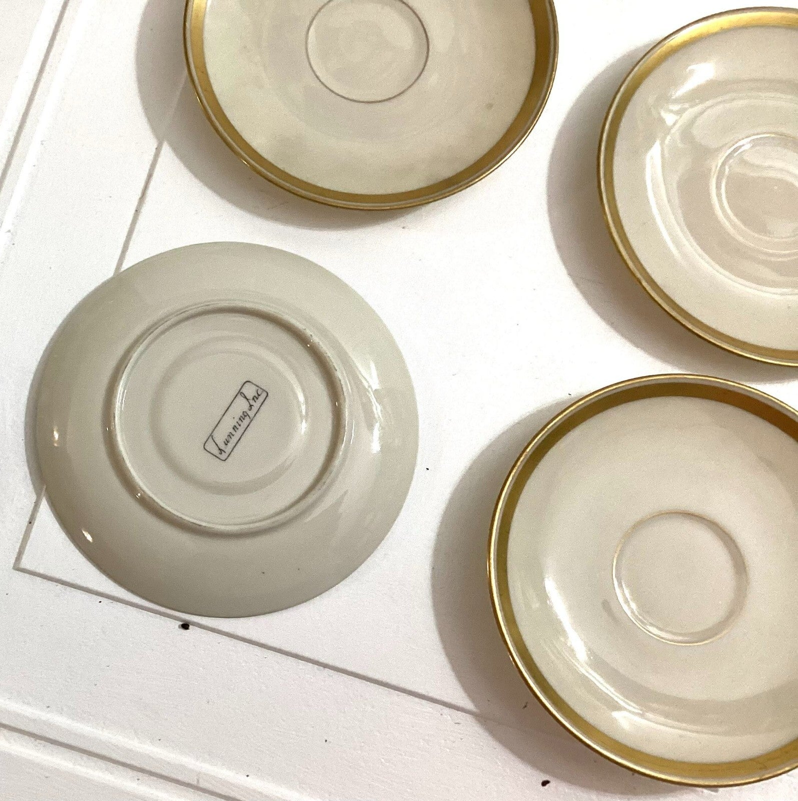 Lot Of 4 Lunning Inc White With Gold Trim Edge Round Shaped Saucers