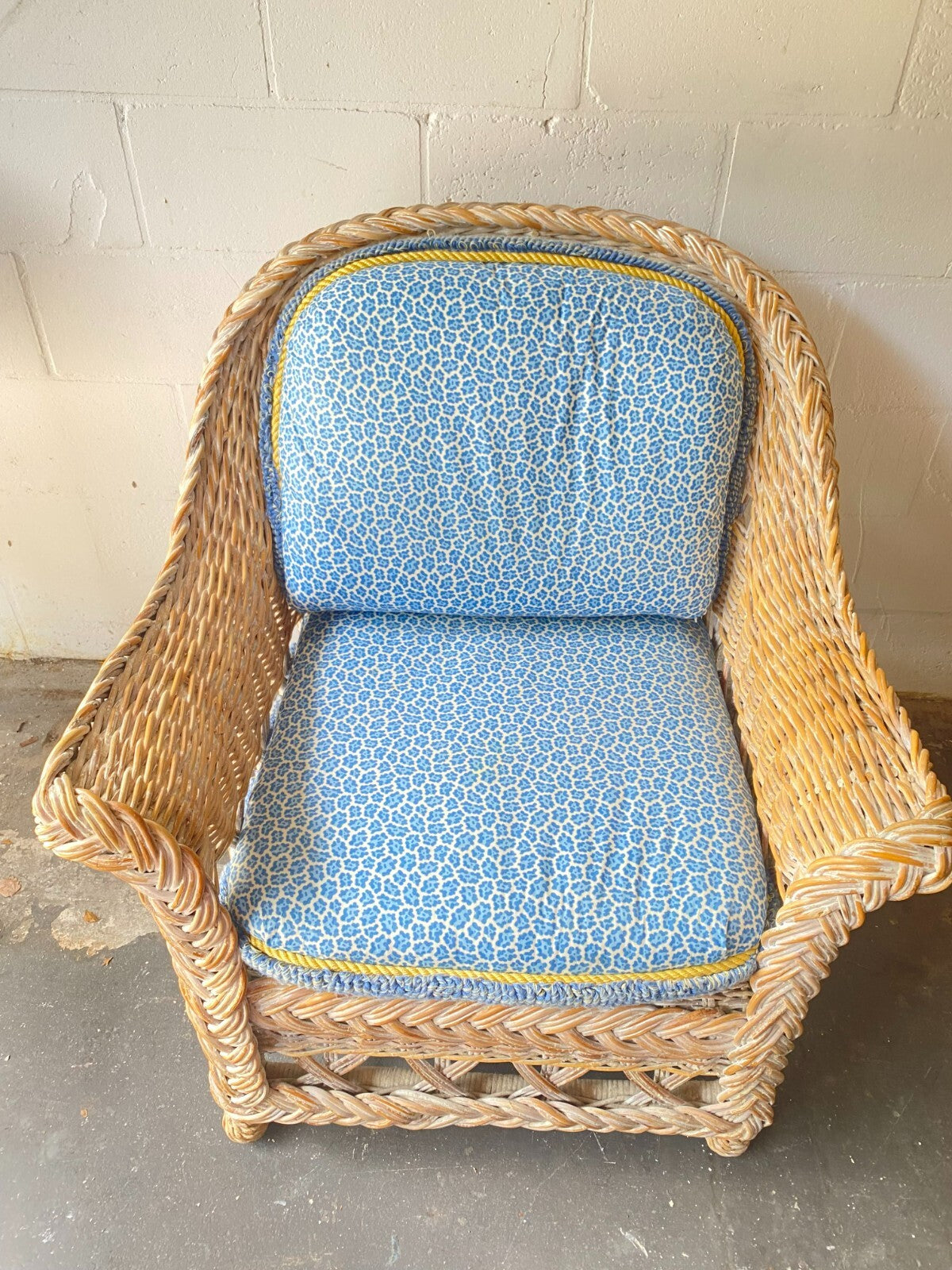 Beige Wicker Chair With Arm Rest Blue Cushion And Square Matching Ottoman